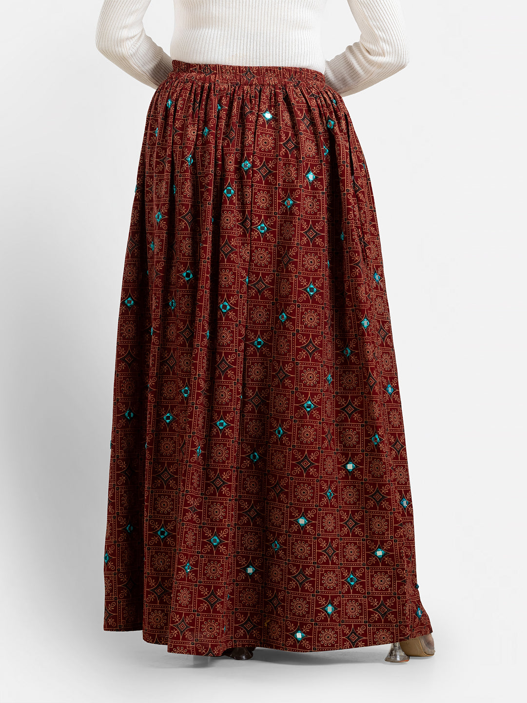 Printed maroon women's long skirt from Crazy Needle Online, featuring floral patterns and flowing fabric.