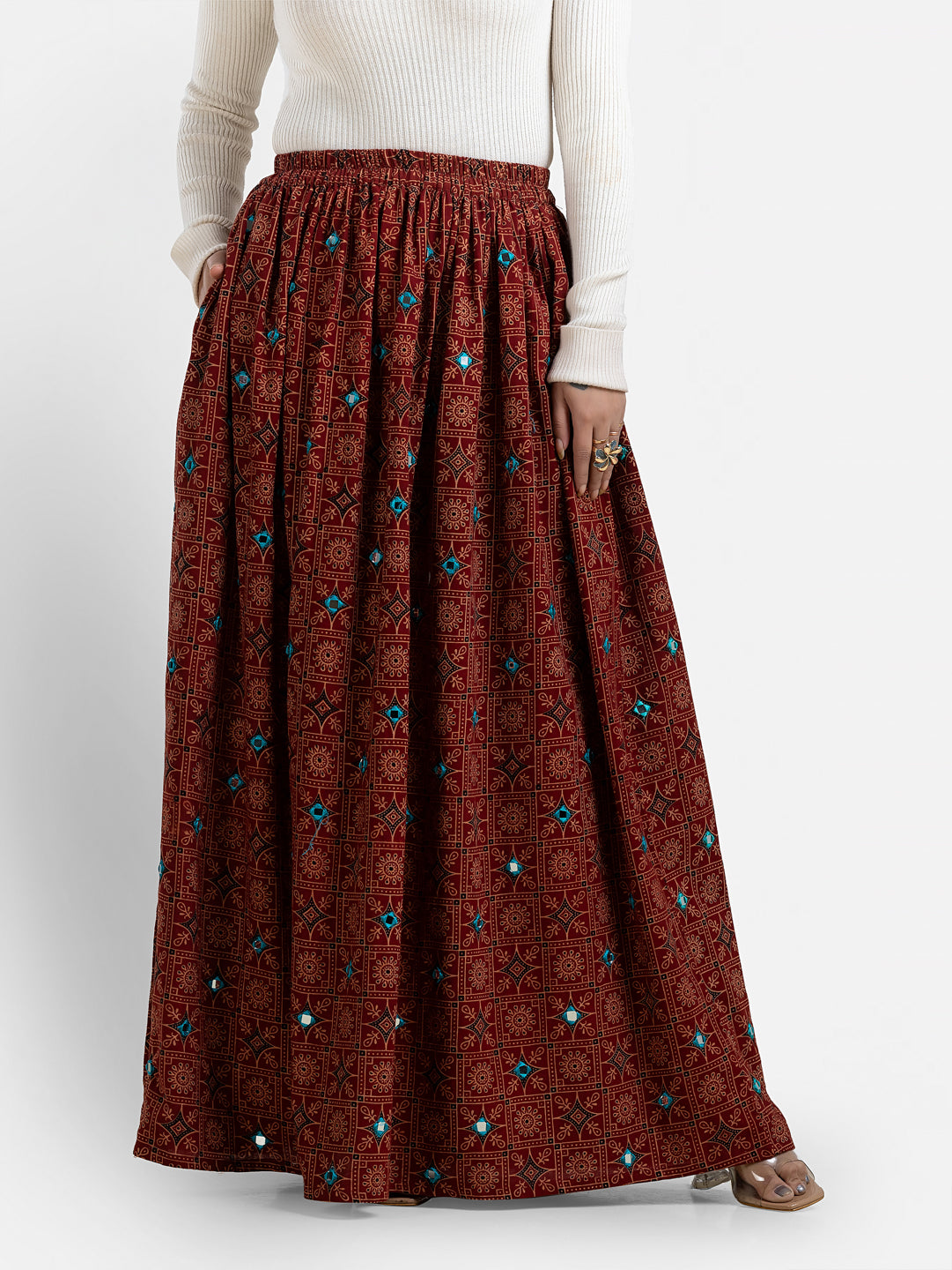 Women's printed maroon long skirt by Crazy Needle Online, featuring a flowy design and intricate pattern, perfect for casual wear.