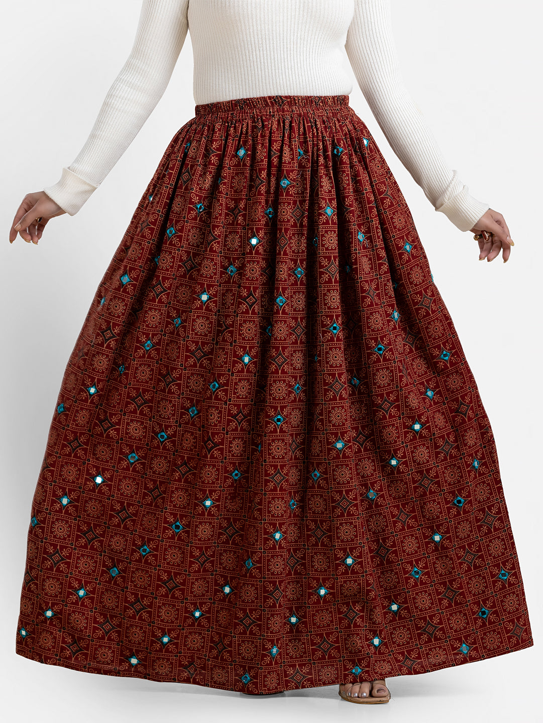 Women's printed maroon long skirt from Crazy Needle Online, featuring floral patterns and flowing fabric.