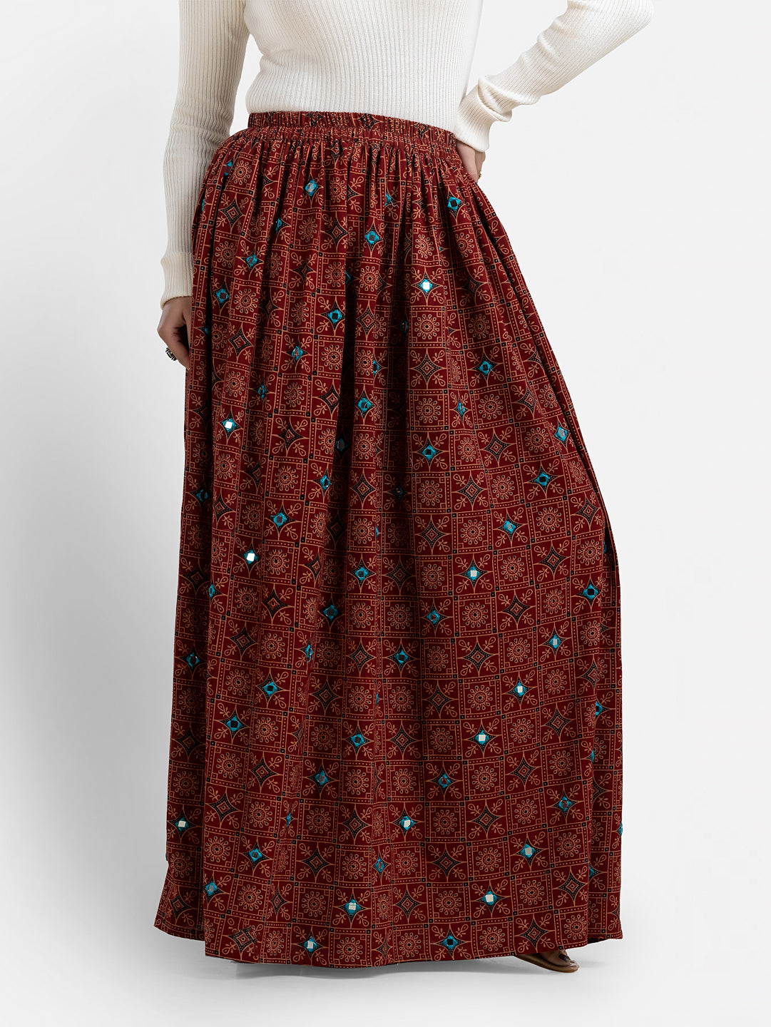 Maroon printed women's long skirt from Crazy Needle Online, featuring a flowing design and vibrant pattern.
