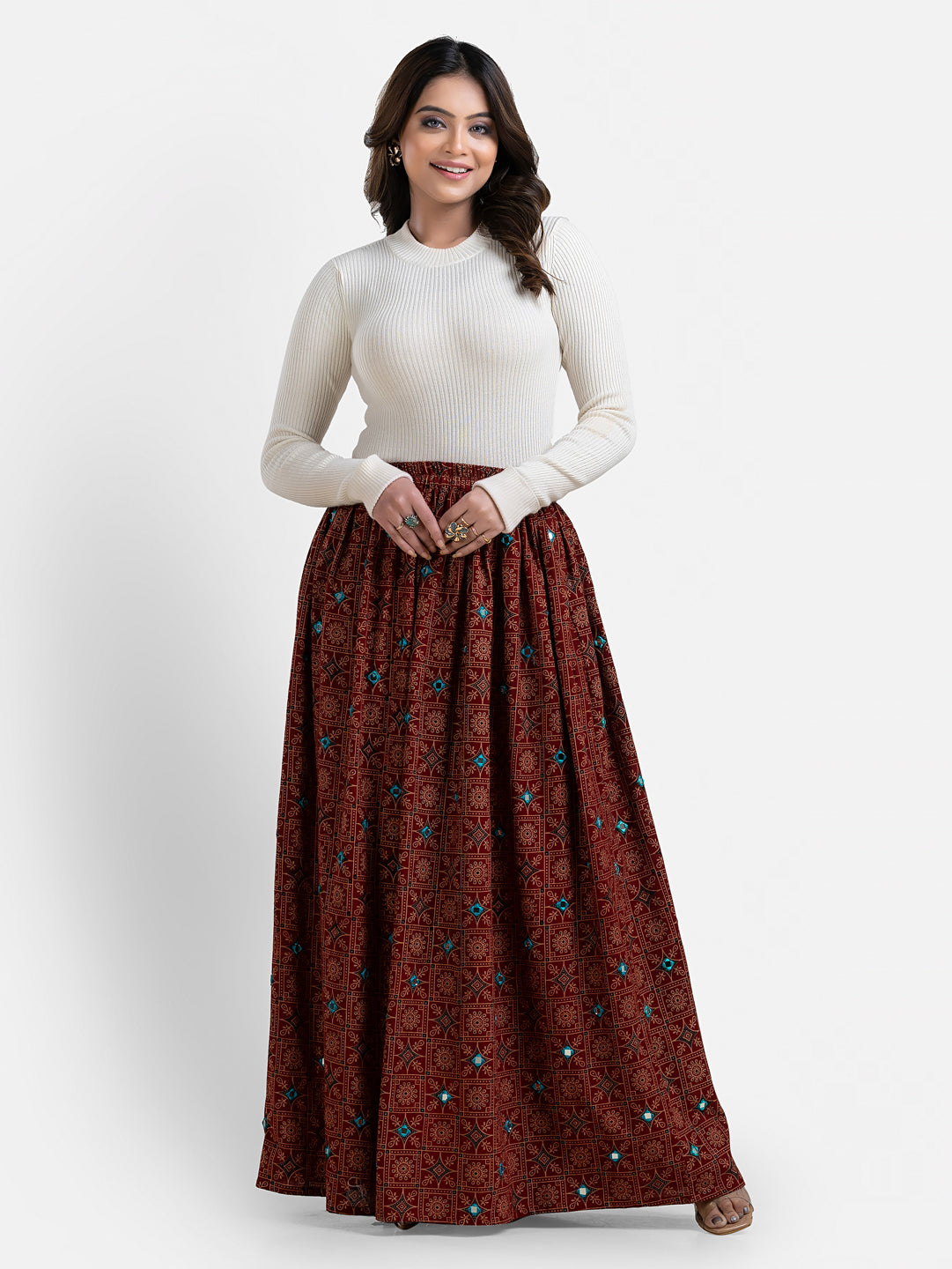 Women's maroon printed long skirt by Crazy Needle Online, flowing fabric with intricate patterns, perfect for casual or dressy occasions.