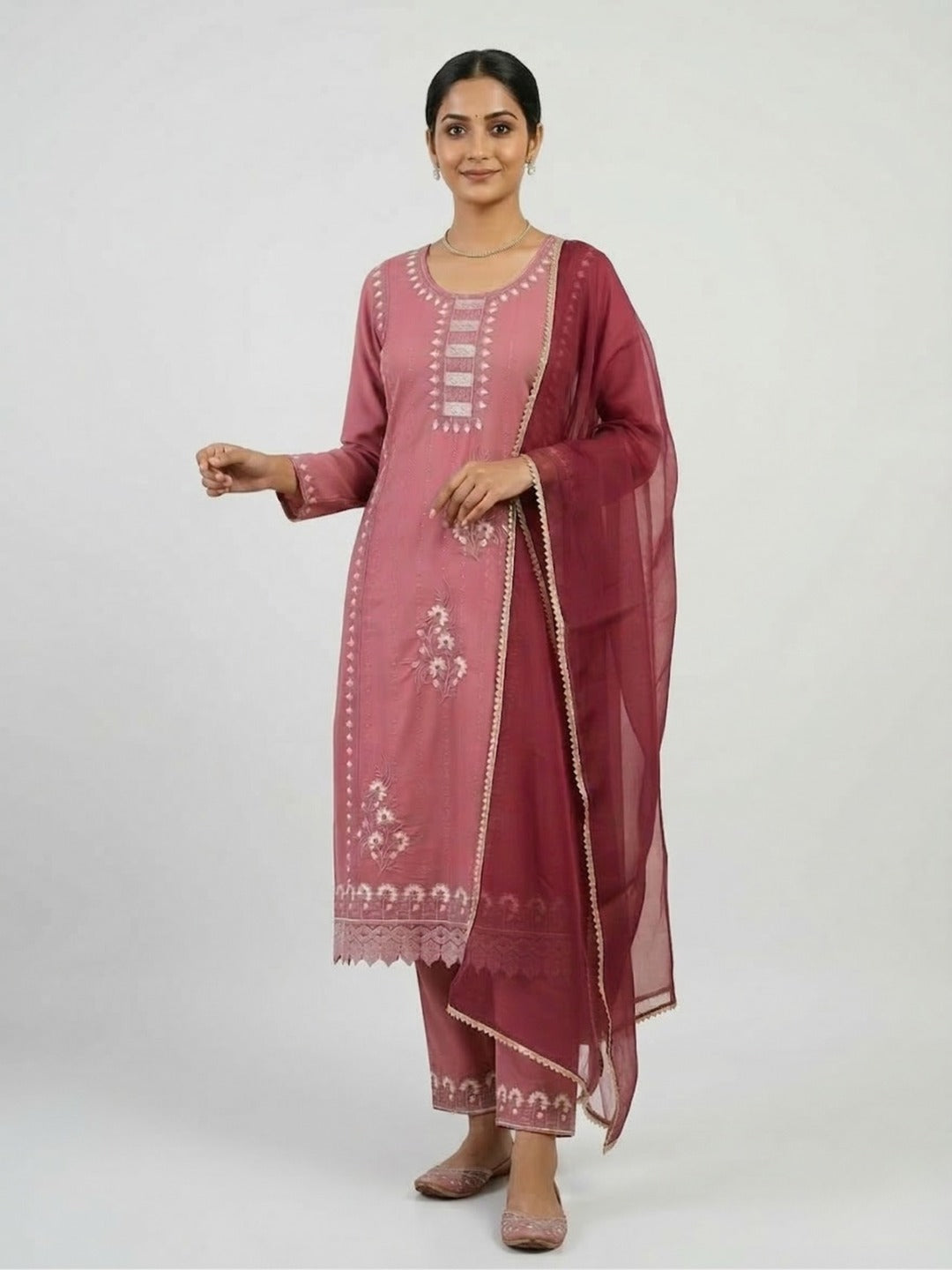 Women's peach handwork kurti and pant set with dupatta, featuring intricate embroidery and traditional design.