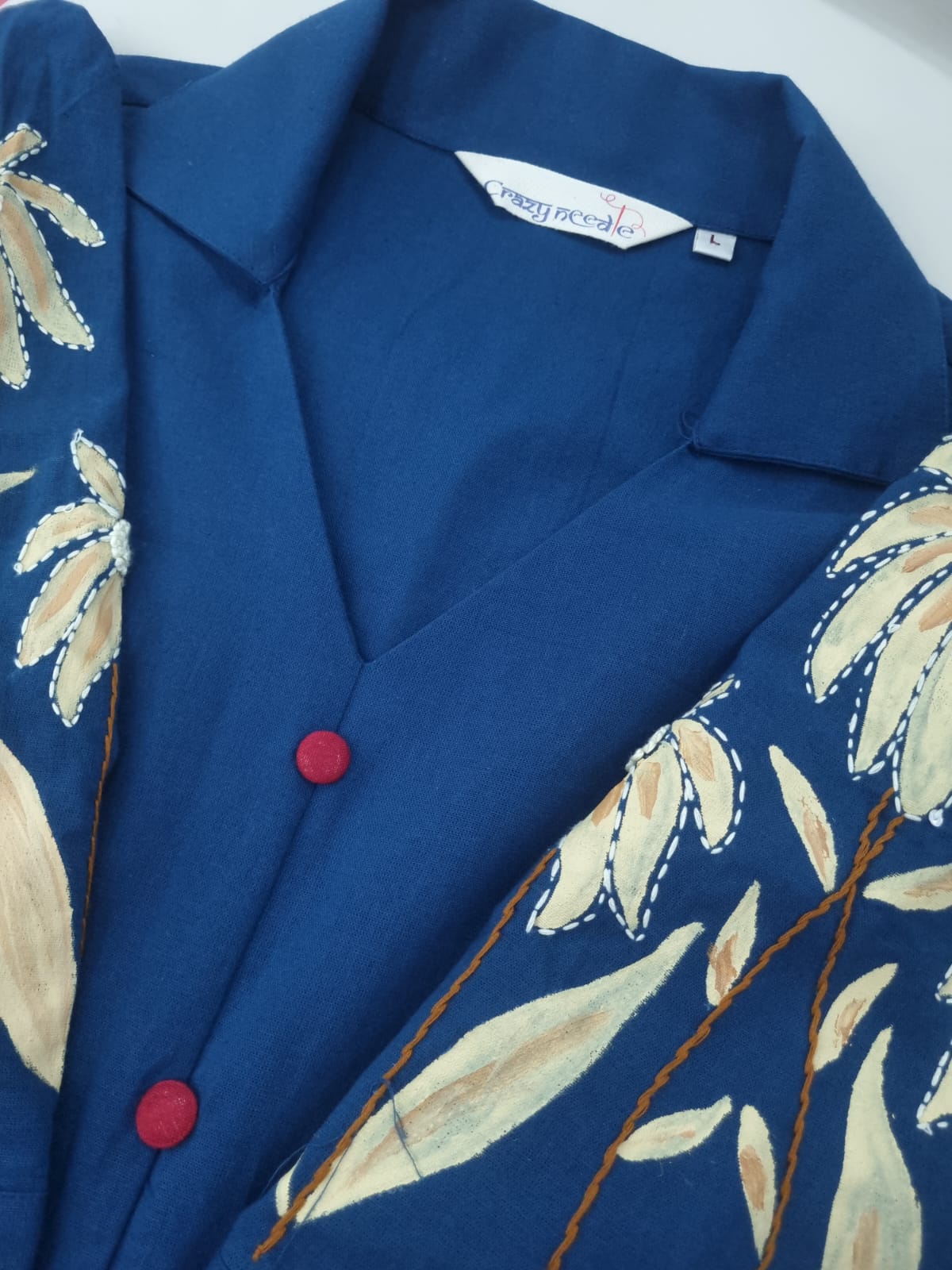 Women's hand-painted blue dress by Crazy Needle Online, featuring intricate floral patterns and flowing fabric design.