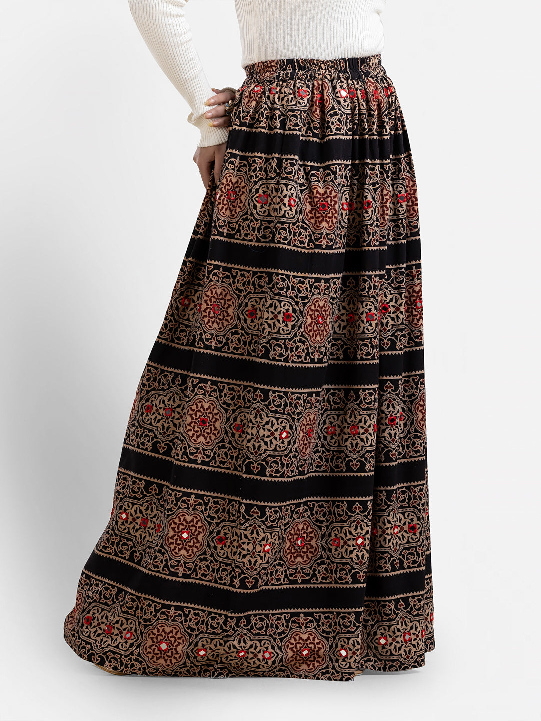 Women's printed black long skirt from Crazy Needle Online, featuring a flowing design and intricate pattern.