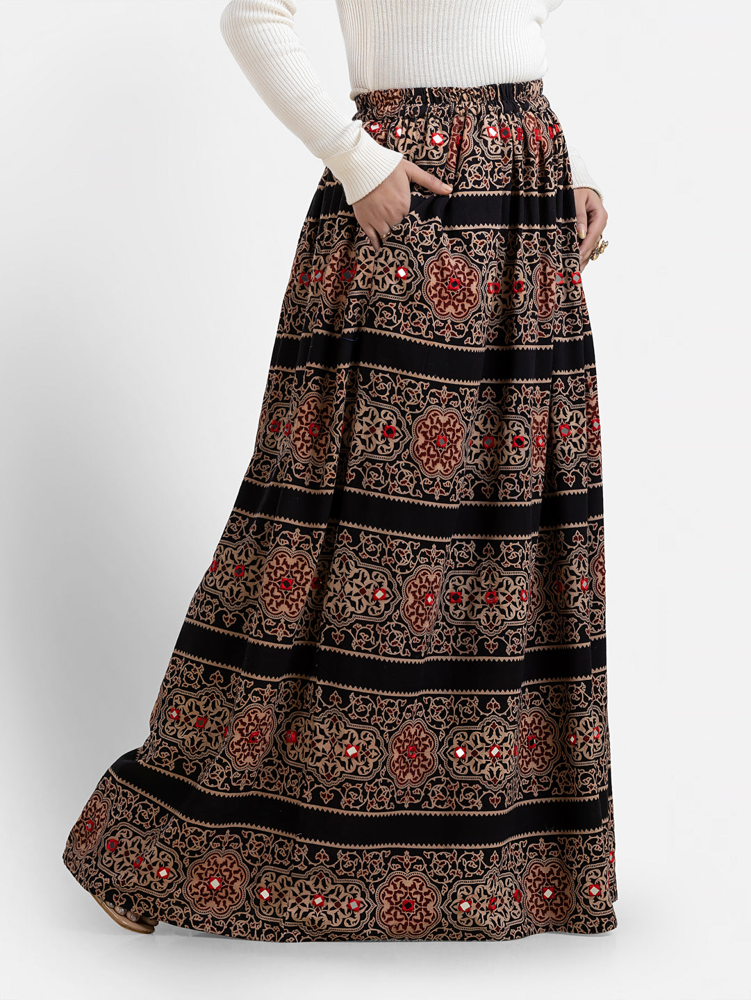 Printed black long skirt for women by Crazy Needle Online, featuring a stylish design and flowing fabric.