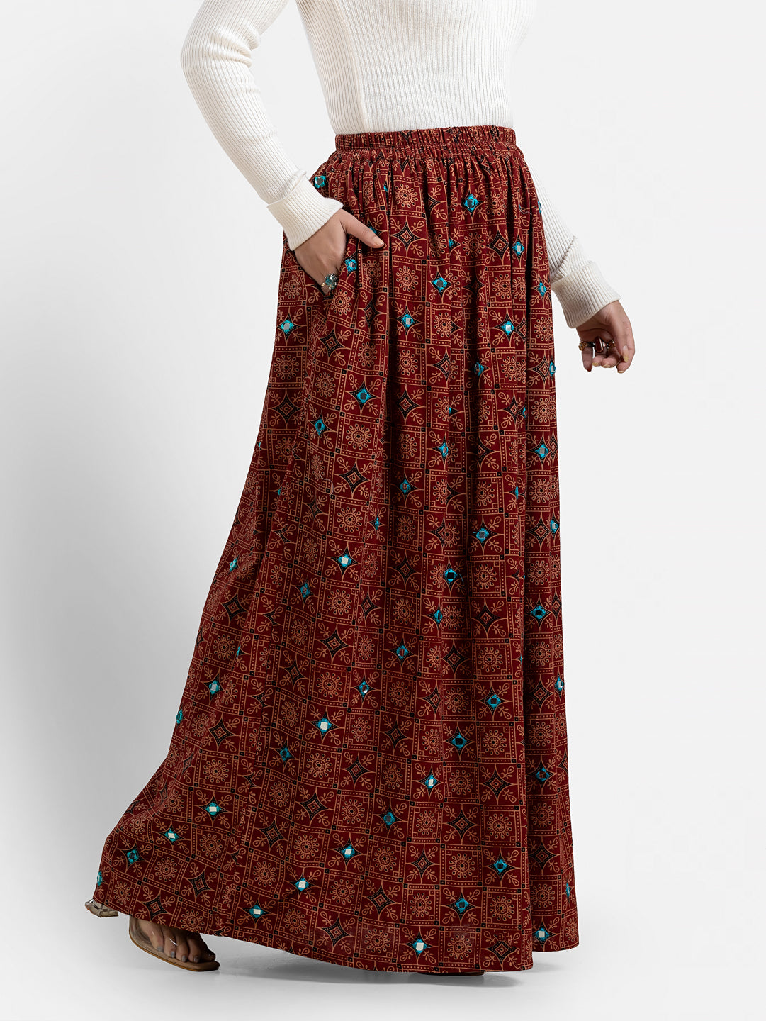 Printed maroon women's long skirt from Crazy Needle Online, featuring a flowing design and intricate pattern.