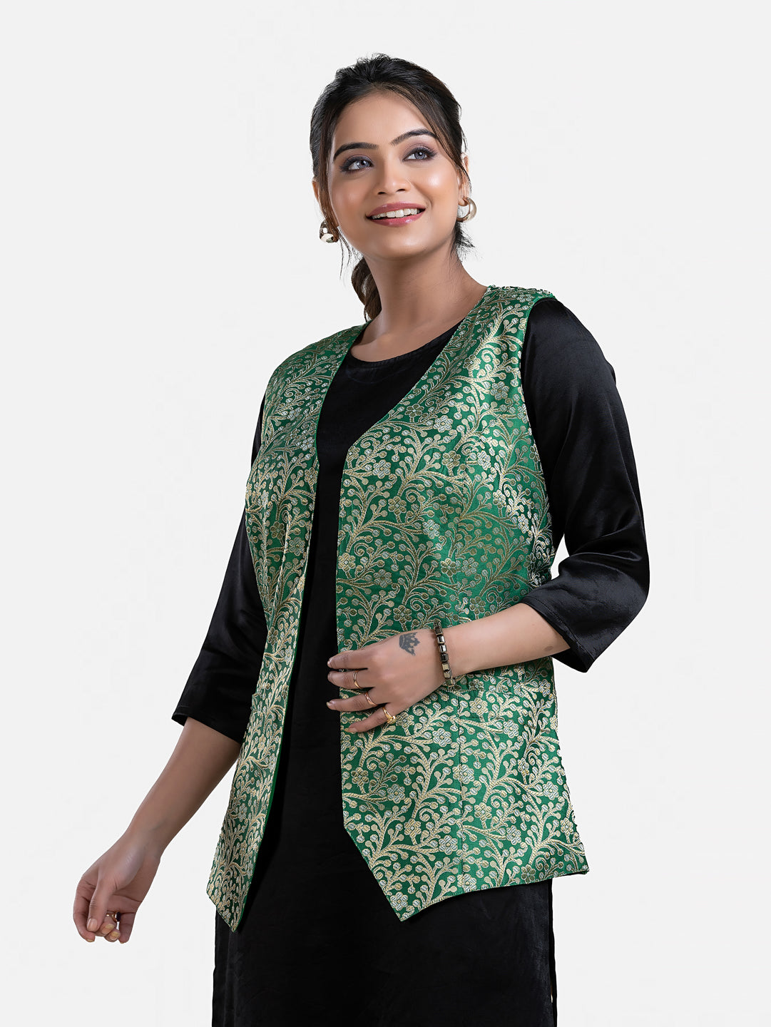 Women's green sleeveless brocade jacket by Crazy Needle Online, featuring intricate fabric design and tailored fit.