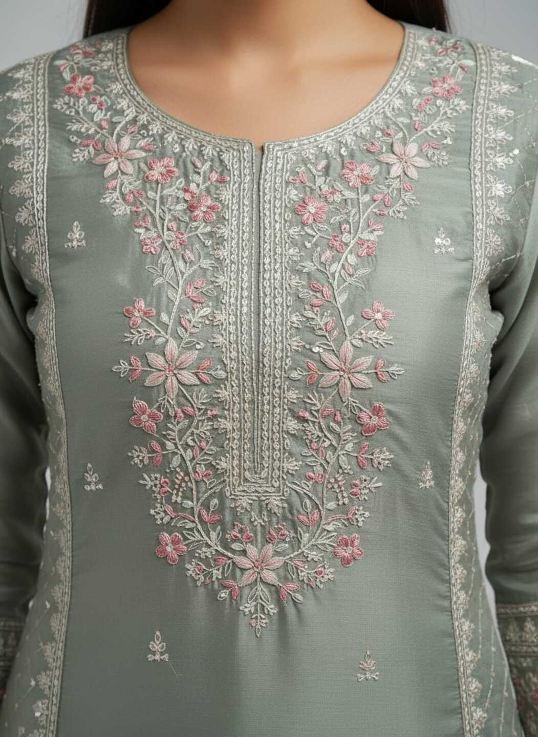 Women’s green kurti and pant set with matching dupatta, featuring traditional embroidery, styled on a model.
