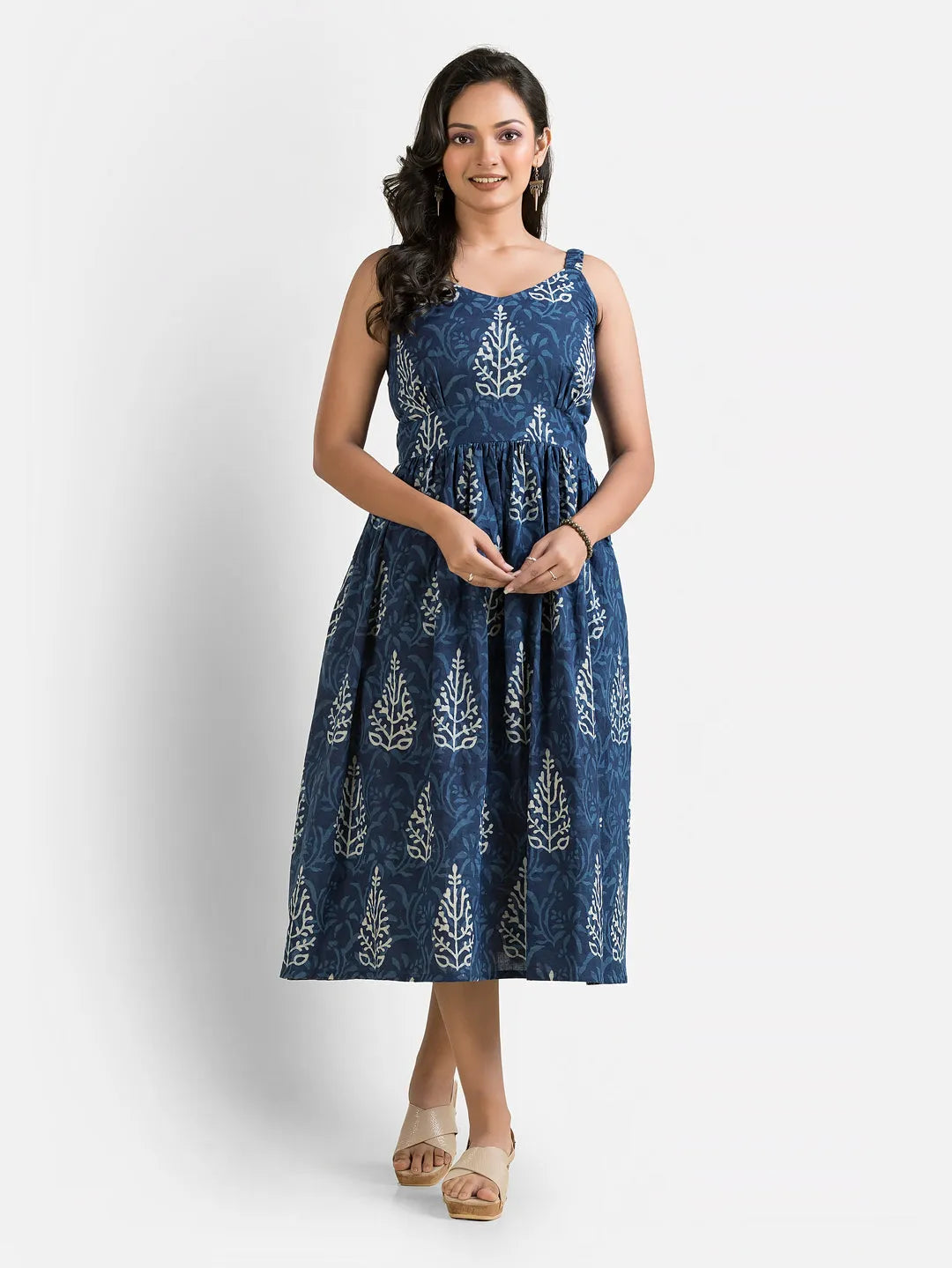 Women's blue gown paired with a maroon jacket, showcasing elegant design and flowing fabric, by Crazy Needle Online.