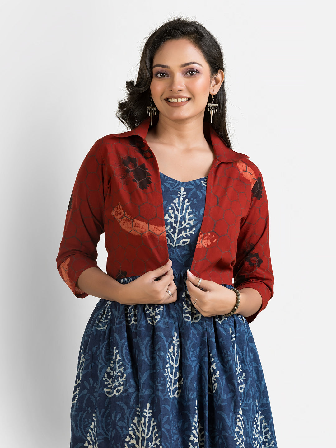 Women's blue gown paired with a maroon jacket, showcasing elegant design and vibrant colors from Crazy Needle Online.