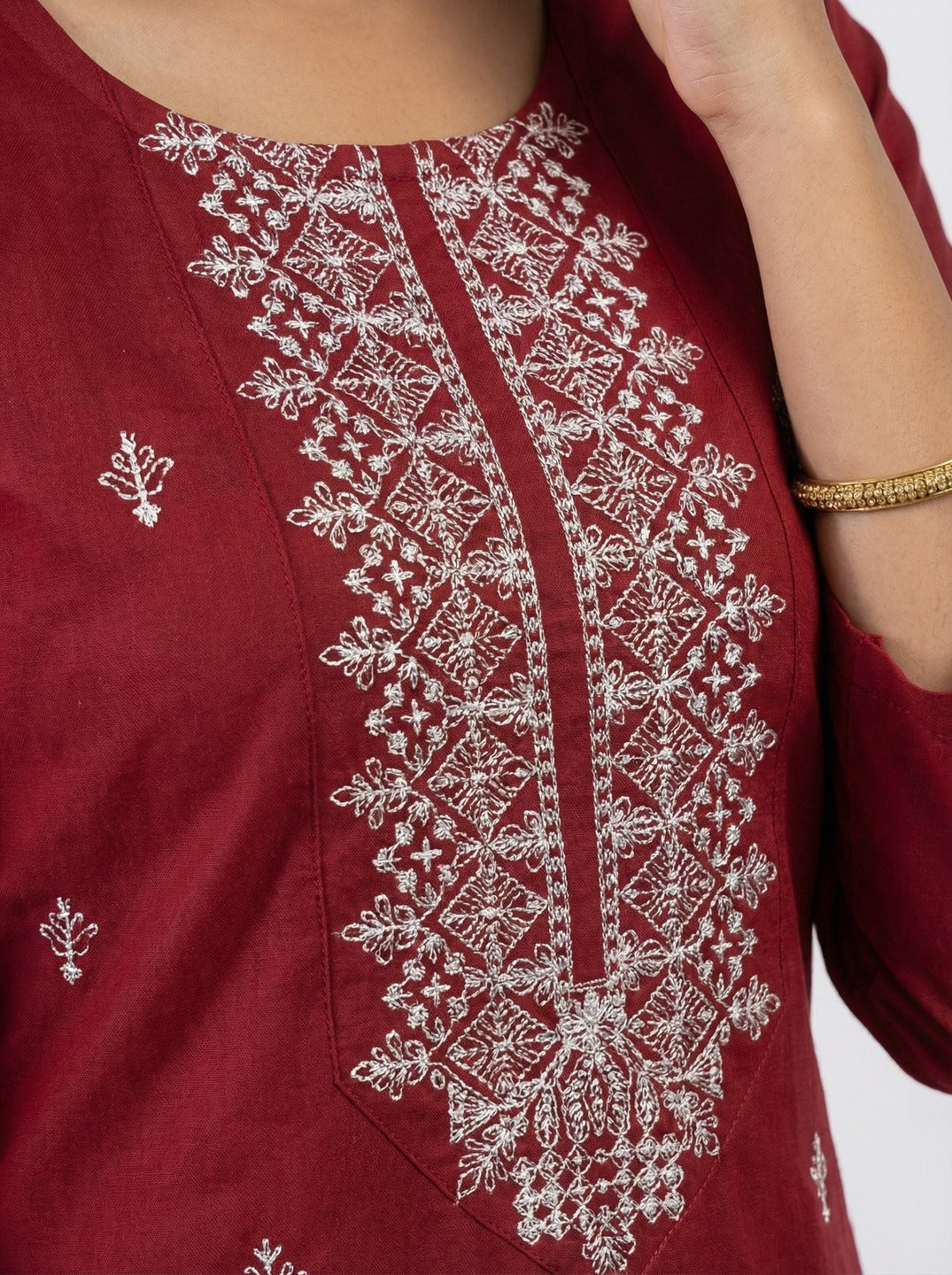 Maroon women's handwork kurti with intricate embroidery, designed by Crazy Needle Online, displayed on a plain background.