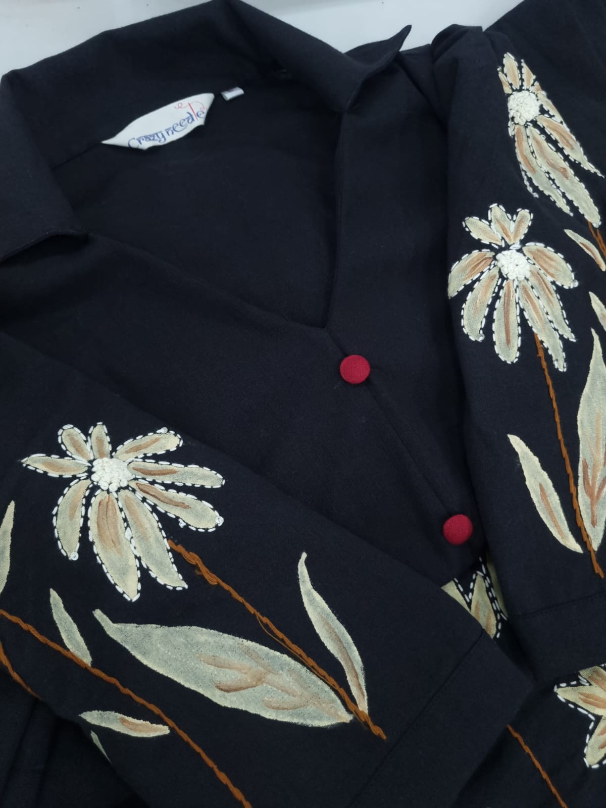 Women’s hand-painted black dress by Crazy Needle Online, featuring artistic floral patterns on a stylish dress.
