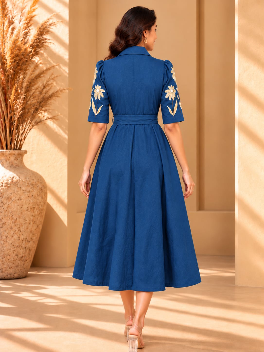 Women's hand-painted blue dress by Crazy Needle Online, featuring vibrant floral patterns and flowing fabric.