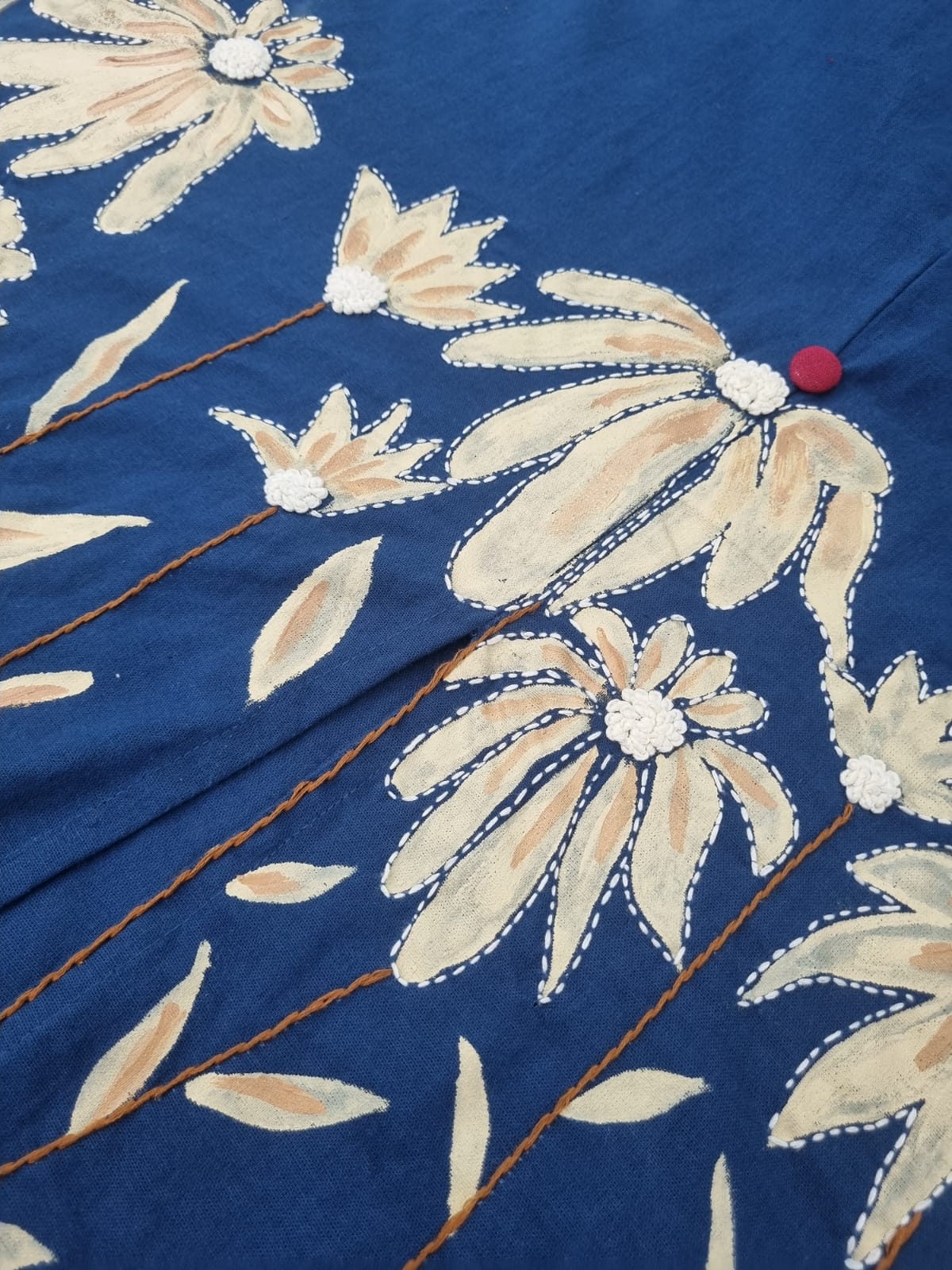 Women’s hand-painted blue dress by Crazy Needle Online, featuring vibrant floral patterns and elegant fabric.